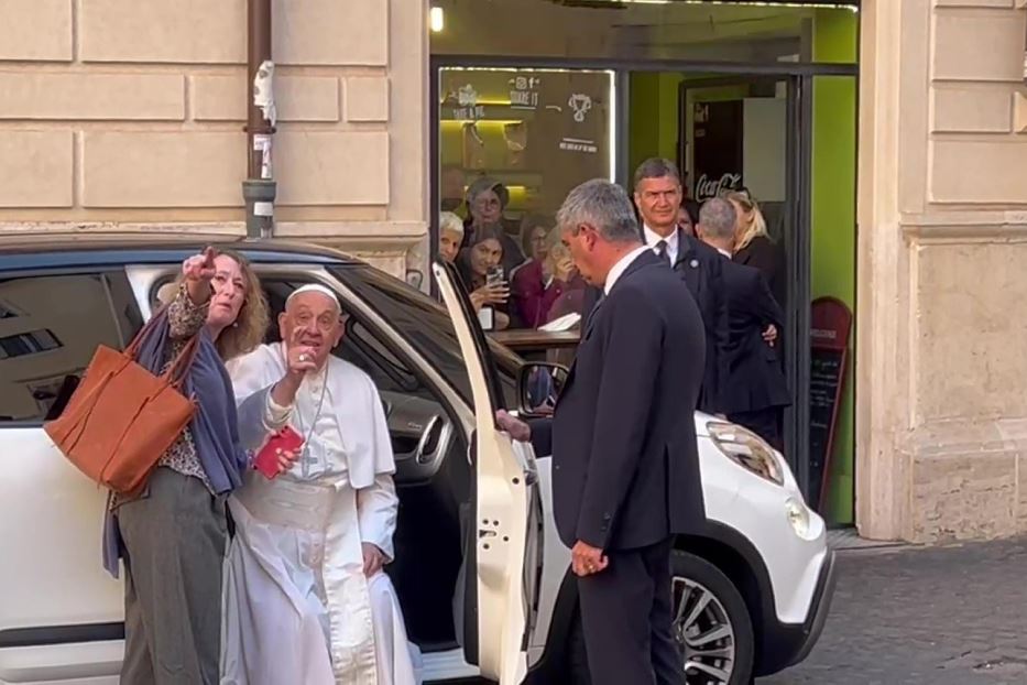 Il Papa con una passante davanti alla casa di Emma Bonino