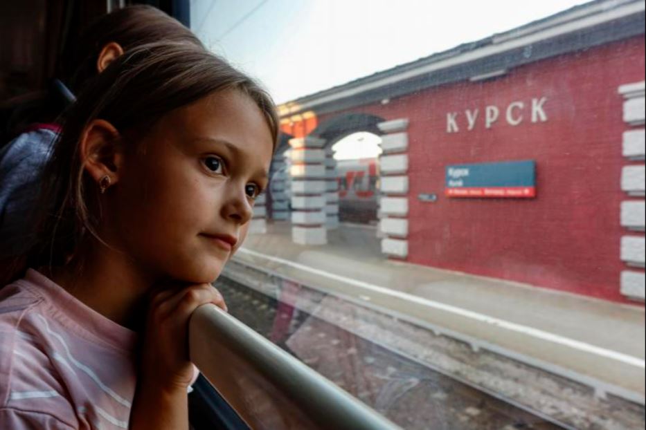 Bambini lasciano a bordo di un treno la regione di Kursk, durante l’offensiva russa in territorio ucraino